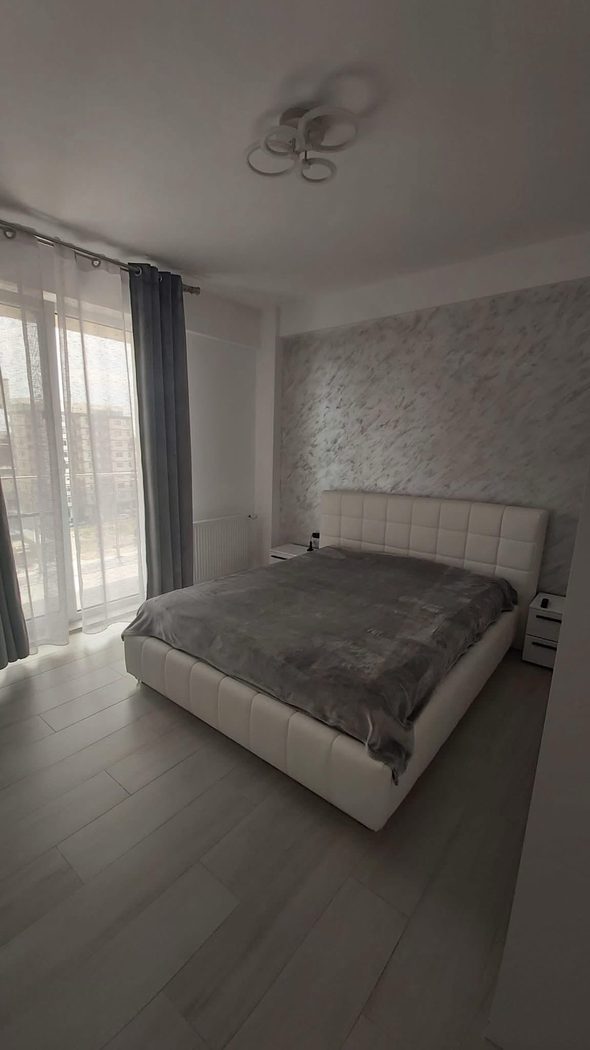 Dormitor elegant cu pat matrimonial și vedere la mare